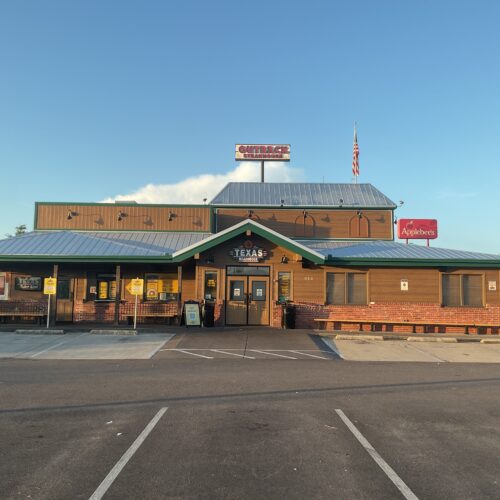 Front side of a Texas roadhouse of a exterior remodel of tin and skin in Slidell, TX.