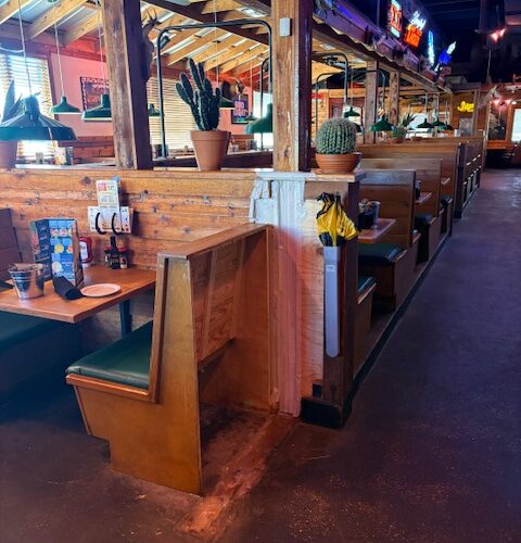 Interior of Texas Roadhouse Lafayette, LA during front-of-house remodel with booths, bar area, and seating layout updated for ADA accessibility.