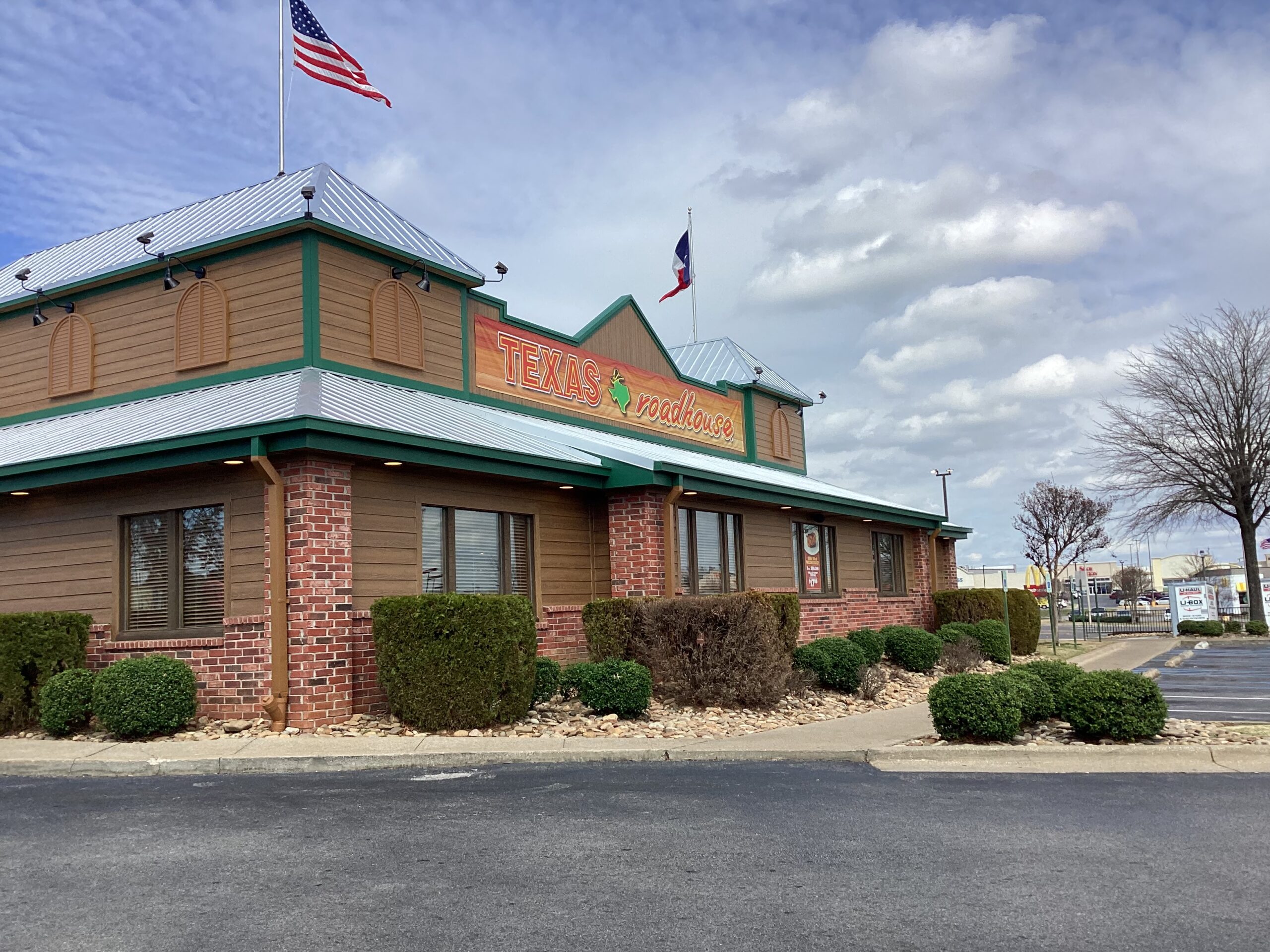 Texas Roadhouse Florence Alabama completed exterior retin and reskin model with new metal roof, woodtone siding, trim, and soffit upgrades.