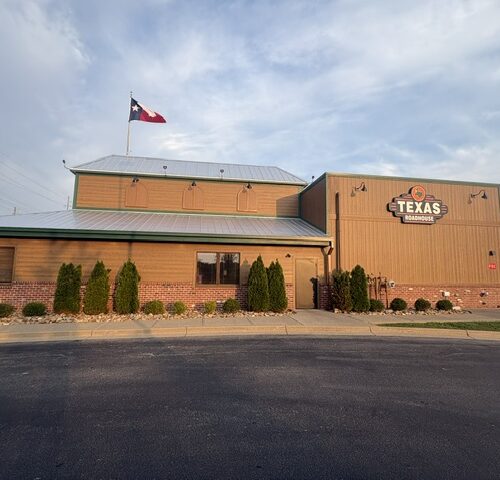 Exterior view of a Texas Roadhouse restaurant in Middletown, Kentucky during and after exterior renovation work featuring new siding, roofing, lighting, doors, and signage upgrades.